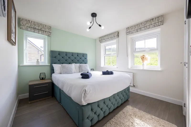 Bedroom 1 with a king-size bed and two windows