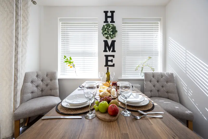 Dining table set for a meal in the bright dining area
